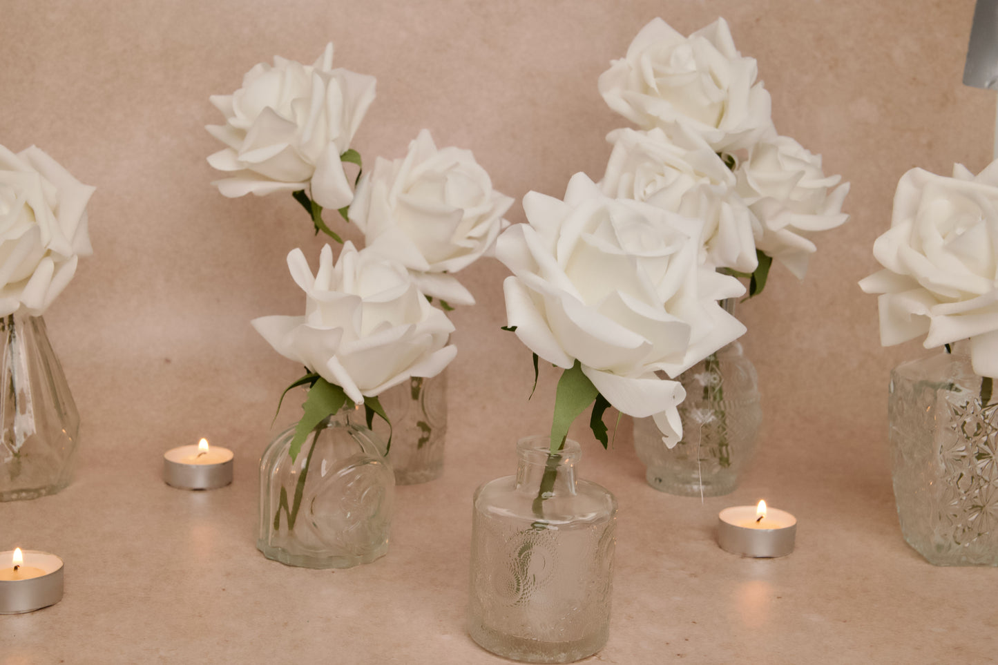 Elegant wedding table decorations with artificial, real-touch white roses