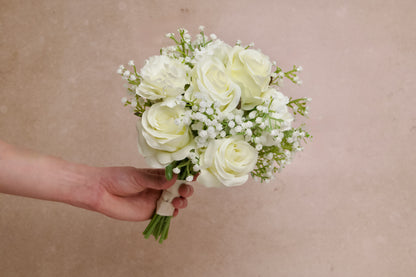 Bridal bouquet made of white roses, carnations and babys breath for wedding rental