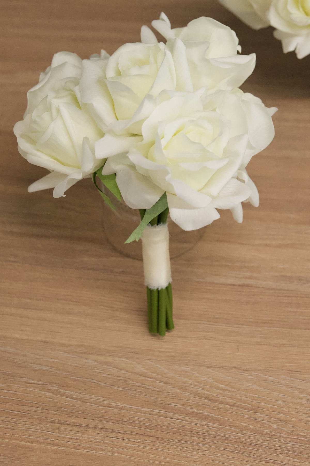 Bridesmaid bouquet made of artificial, real-touch white roses for weddings